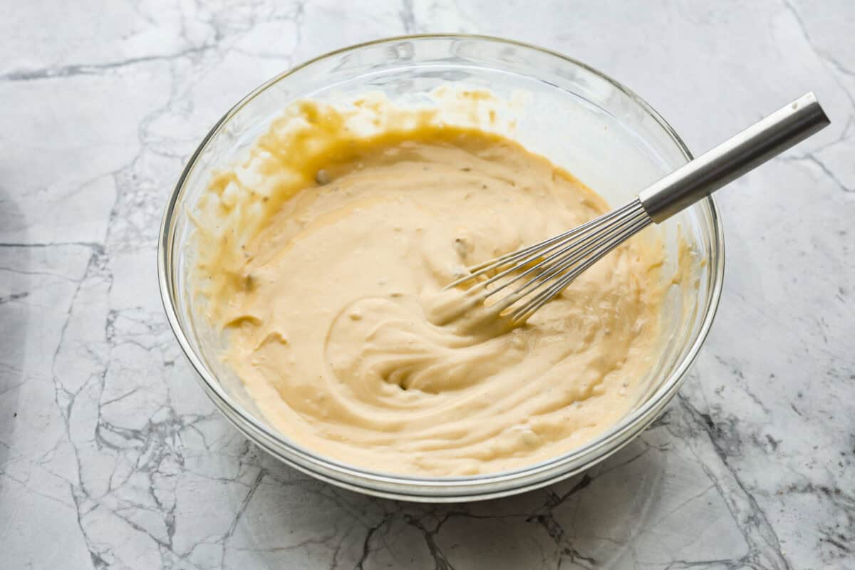 Overhead shot of soup milk and Worcestershire sauce in a glass bowl. 