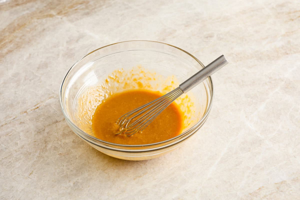 Miso chicken is super delicious and perfect for fans of bold Asian flavor. The skin crisps up, the meat stays juicy and tender, and the glaze caramelizes, creating a savory sauce perfect for drizzling over rice. Angle shot of the marinade ingredients whisked in a bowl.