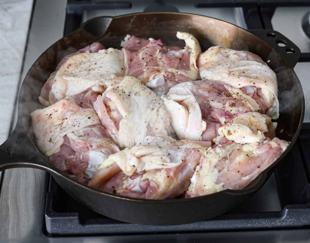 This incredibly tasty Coca-Cola chicken thigh recipe can be on the table in 40 minutes. The succulent sauce is a combination of savory soy sauce, Worcestershire, garlic, ketchup, and, of course, Coca-Cola. You've never had more flavorful chicken thighs than these! Angle shot of chicken thighs cooking in a skillet.