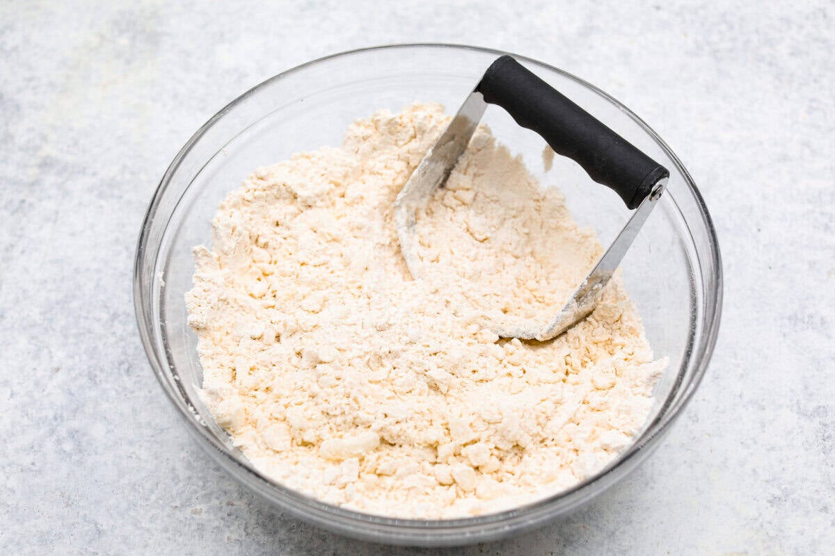 Overhead shot of four and salt in a mixing bowl. 