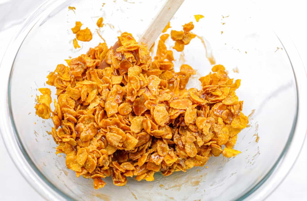 A shot of corn flakes is topped with a mixture of butter and sugar. 