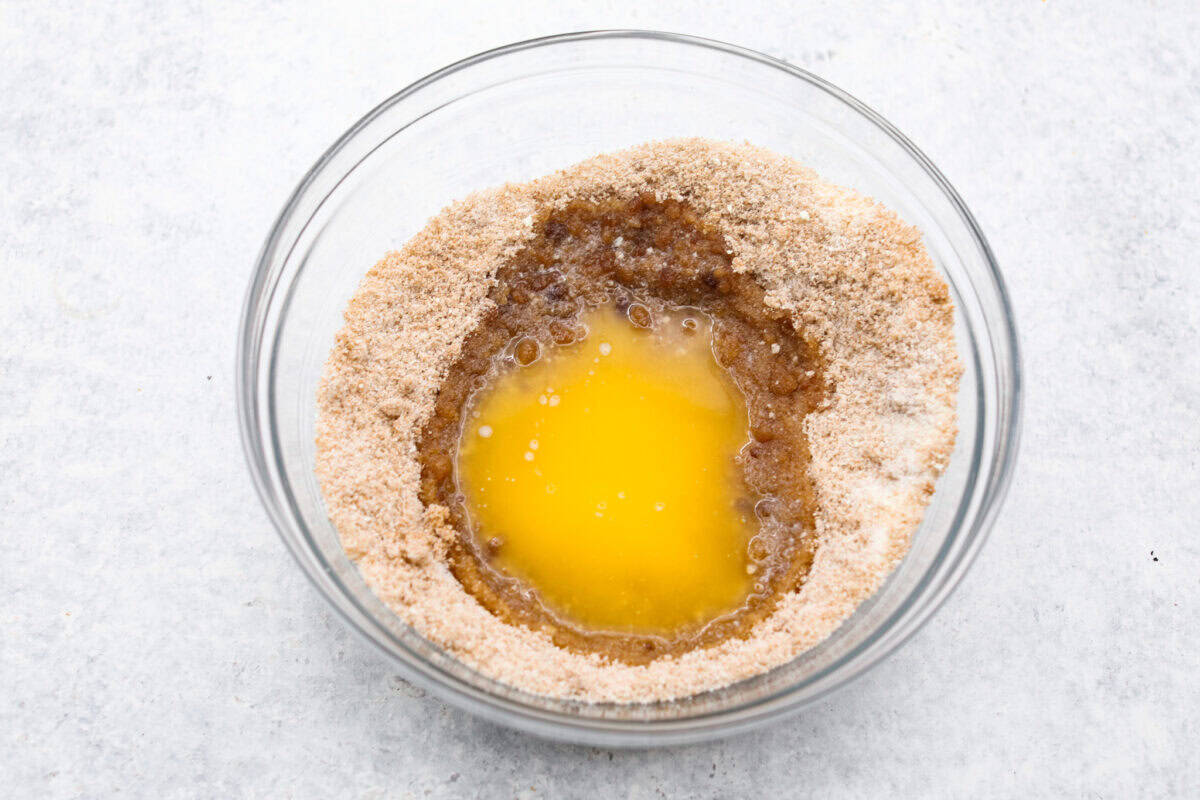 Overhead shot of sugar mixture and melted butter in a bowl.  