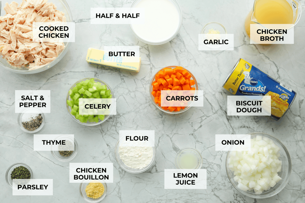 Chicken pot pie casserole is a fun twist on the classic pot pie. It's made with buttery biscuit dough, tender chicken, crunchy veggies, and the most delicious creamy sauce loaded with incredible seasoning. Comfort food at its finest! Overhead shot of labeled ingredients.