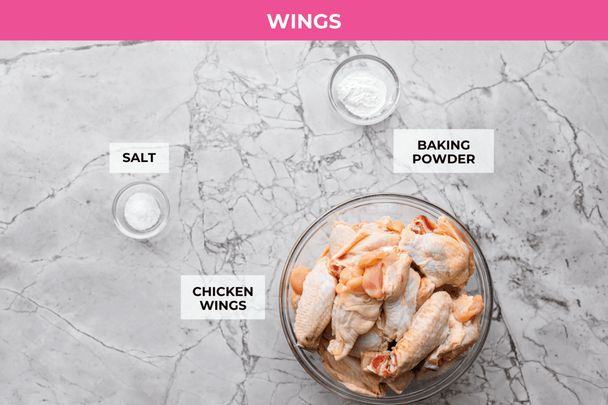 These sweet and sour wings are the perfect appetizer to serve for your next party, game day, or after-school snack. They are baked to crispy perfection and then doused in a sticky, sweet, and sour sauce. Overhead shot of labeled wings ingredients.