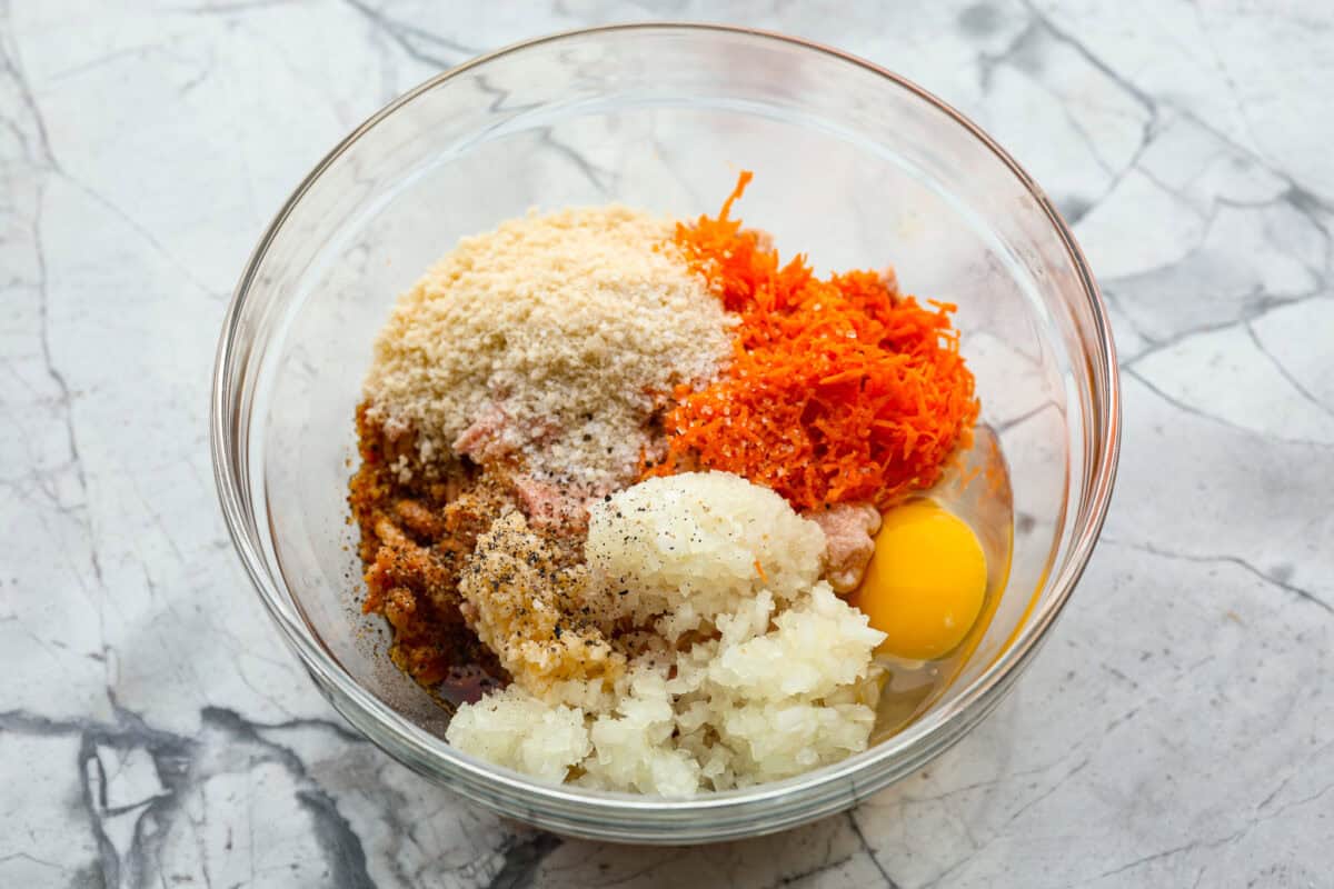 First photo of the meatball ingredients added to a bowl.