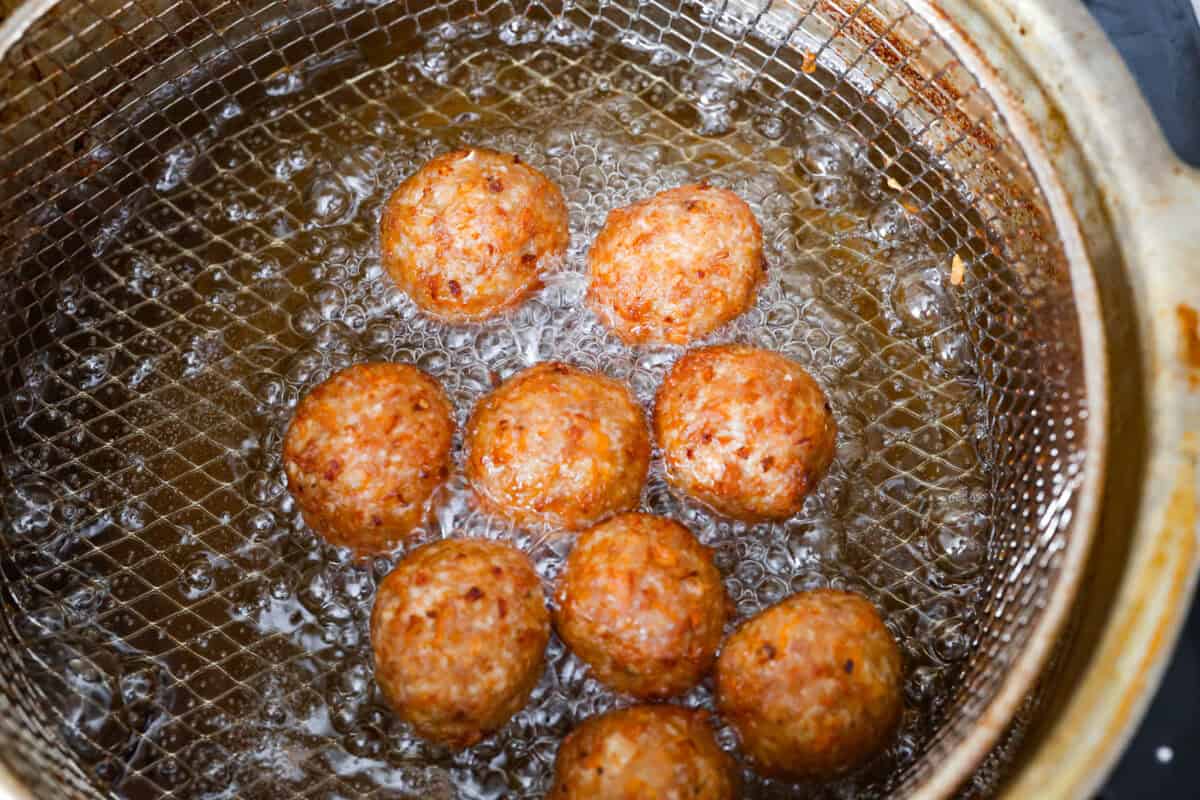 Fourth photo of the bola bola meatballs frying.