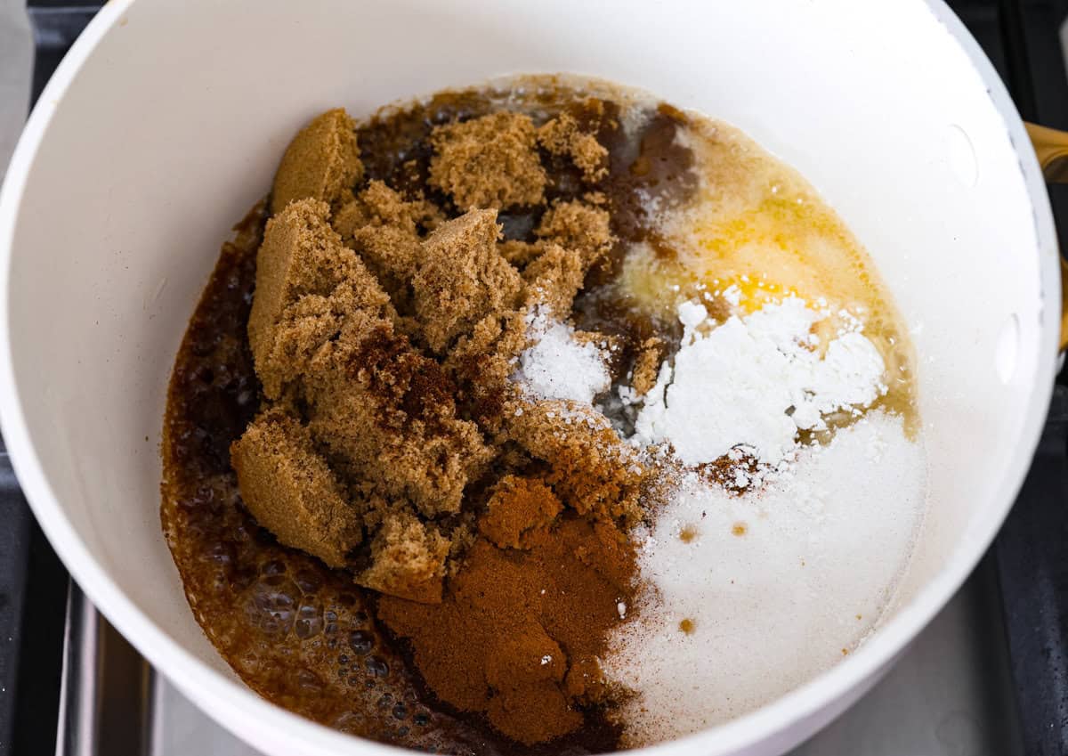 Baked candied yams are one of my favorite Thanksgiving side dishes. The succulent potato texture mixed with the sweet brown sugar spiced sauce, baked to candy perfection, tastes incredible. Overhead shot of butter sugars and spices in a saucepan.