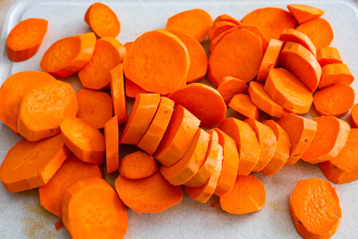 Overhead shot of sliced up yams on a cutting board. 