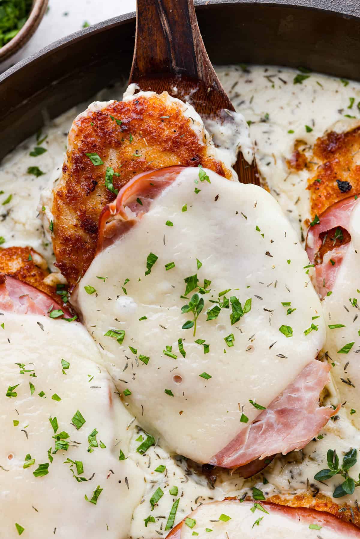 Skillet chicken cordon bleu is one of those recipes my whole family loves. You can't beat the creamy sauce, crispy chicken, and smokey ham, all covered in melty Swiss cheese. Close up shot of the skillet chicken cordon bleu.