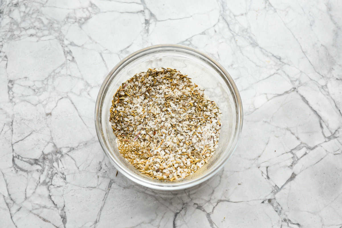 When you dry brine your turkey, you end up with a beautifully browned bird with crispy skin on the outside and juicy, flavorful meat on the inside! It will for sure be one of the most flavorful, moist turkeys you've ever had! Overhead shot of salt and seasonings mixed together in a bowl.