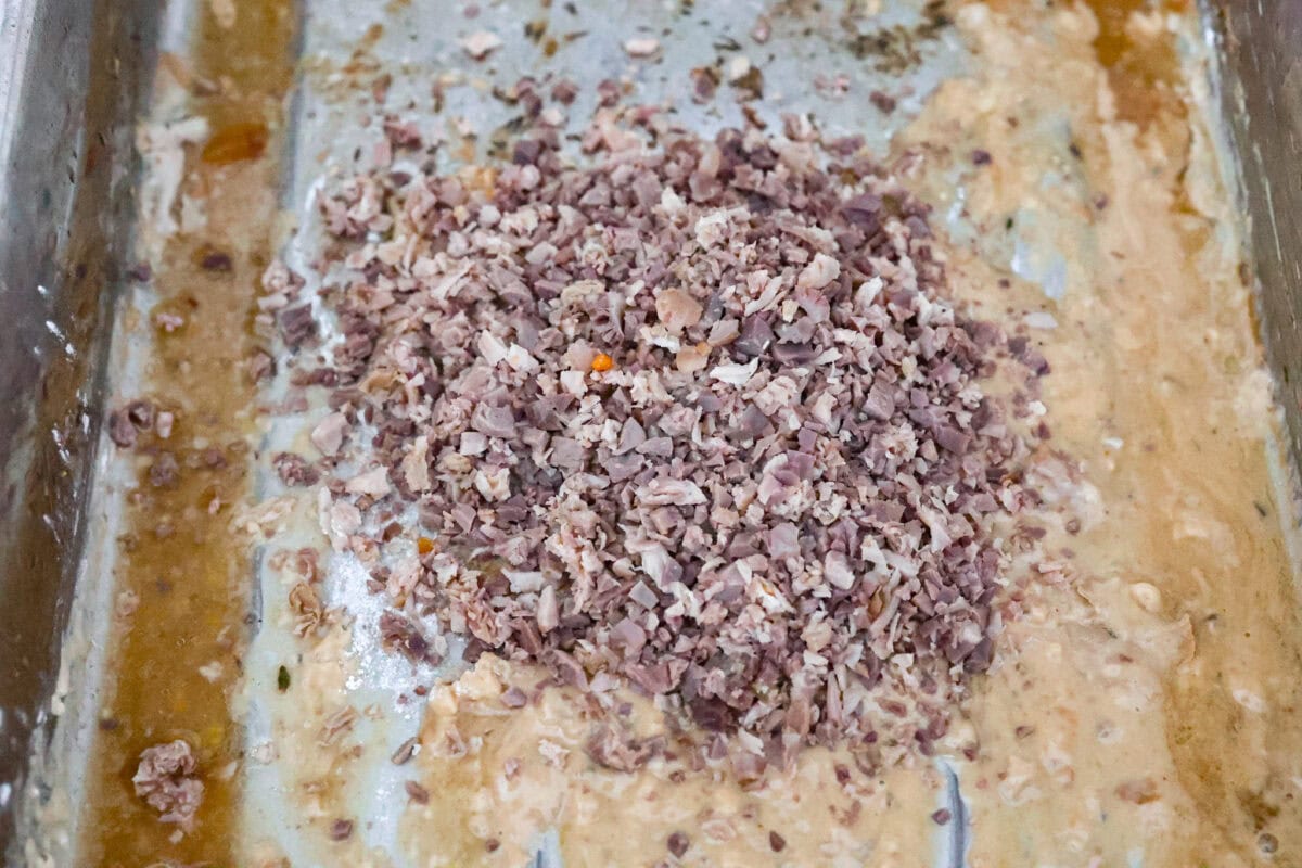 Angle shot of finely diced giblet pieces in the pan with flour an drippings. 