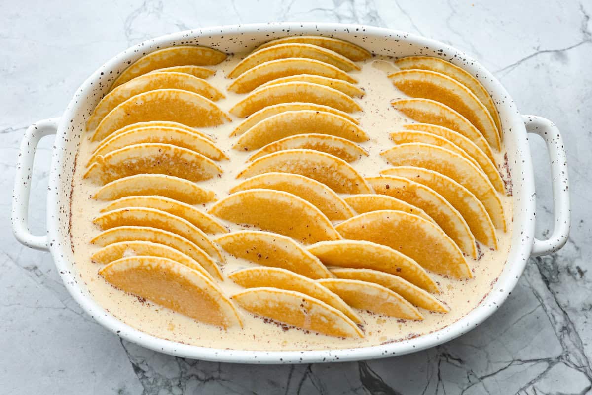 Pancake Casserole is a fun new Christmas or Easter breakfast idea. It has lots of buttery pancakes soaked overnight in a creamy custard, is baked to perfection, and served with your favorite toppings! Overhead shot of the completed dish before being baked.