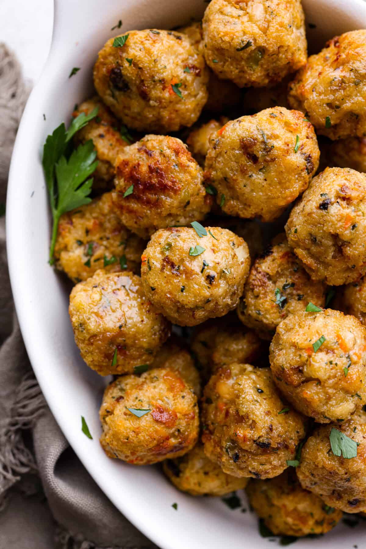 Close up shot of a bowl of turkey stuffing meatballs. 