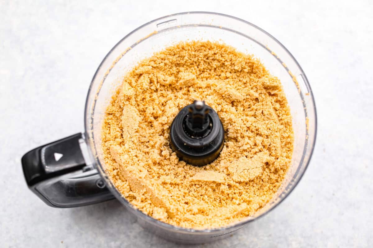 Overhead shot of Oreo cookie crumbs in a food processor. 