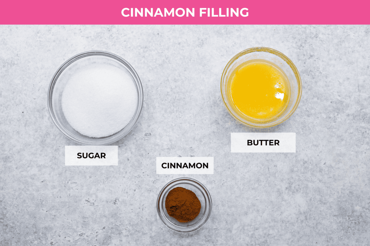 Biscuit Cinnamon Rolls are the most amazing twist on a classic! They are perfectly light, fluffy, and packed with cinnamon. The texture is more flakey and moist than traditional cinnamon rolls! Whether it’s for a cozy weekend breakfast or a holiday brunch, these hit the spot! Overhead shot of labeled cinnamon filing ingredients.
