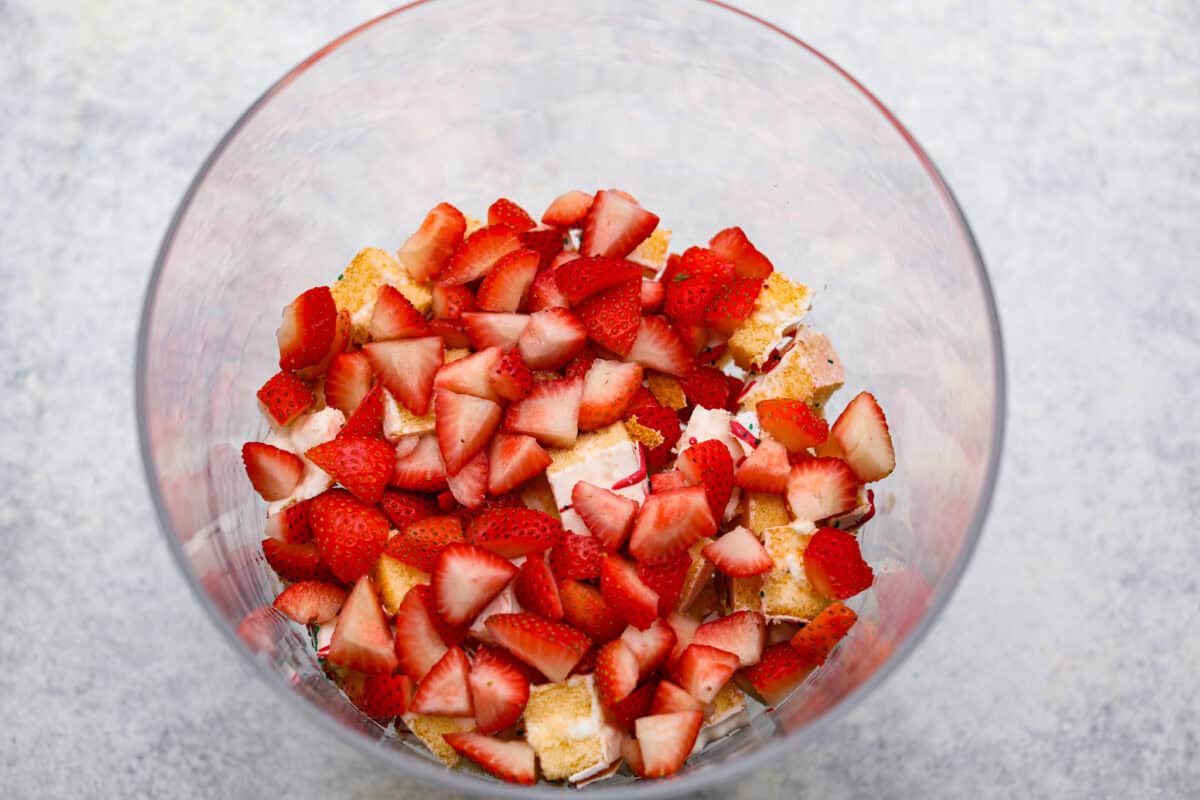 Overhead shot of fresh strawberries on top of the Christmas cake chunks.