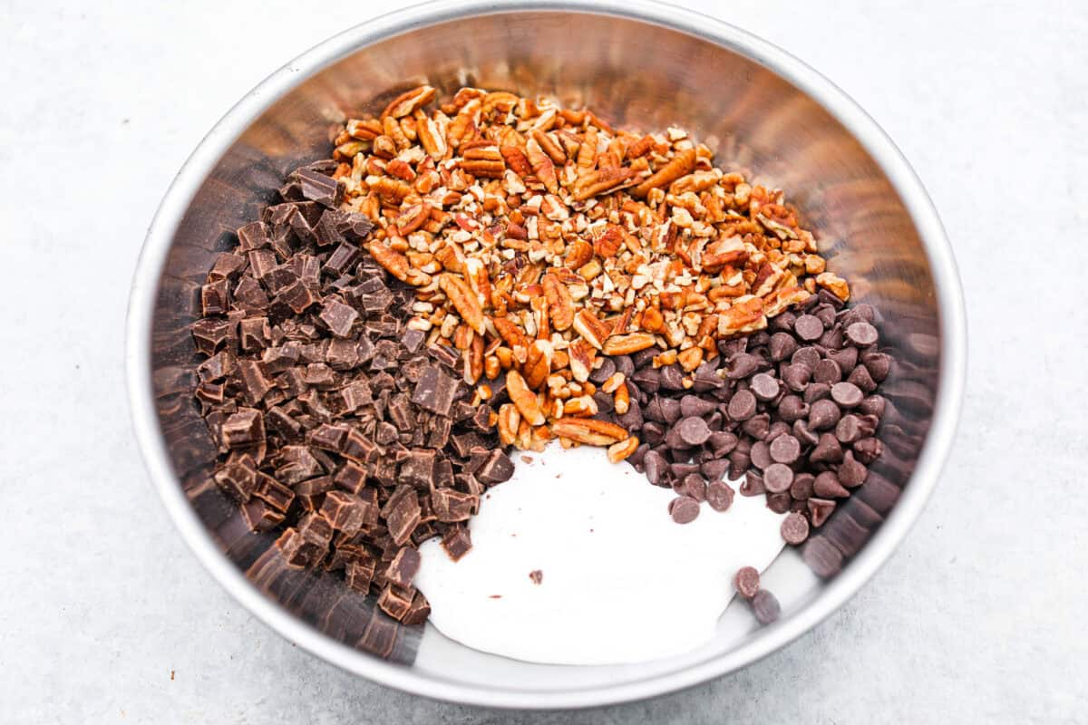 Overhead shot of the chocolate, marshmallow fluff, and pecans in a large bowl.