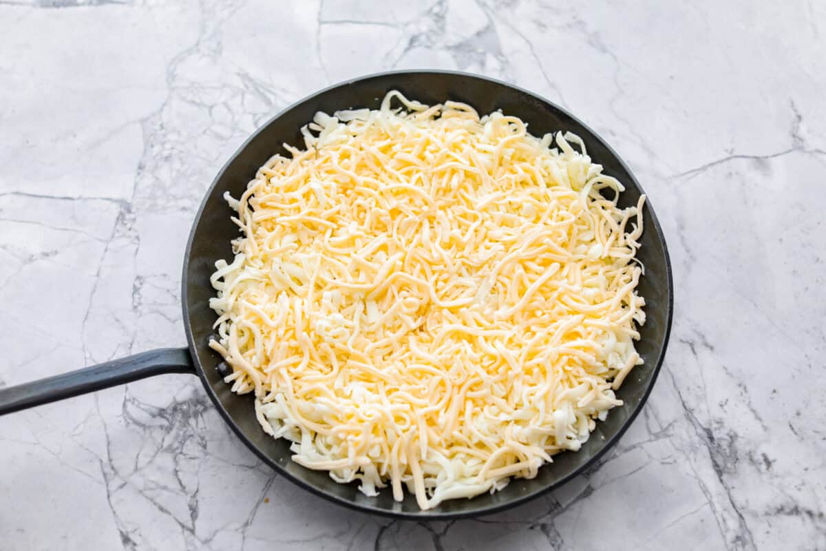 Overhead shot of cheese in a skillet. 