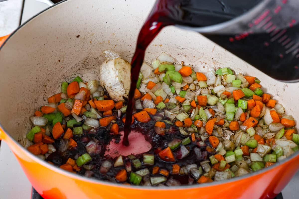 Fifth photo of the red wine pouring into the pot.