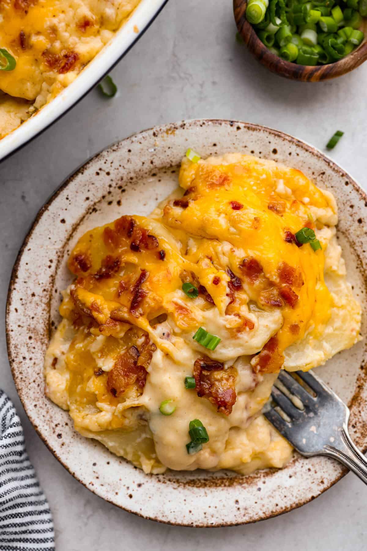 Overhead shot of plated loaded scalloped potatoes. 