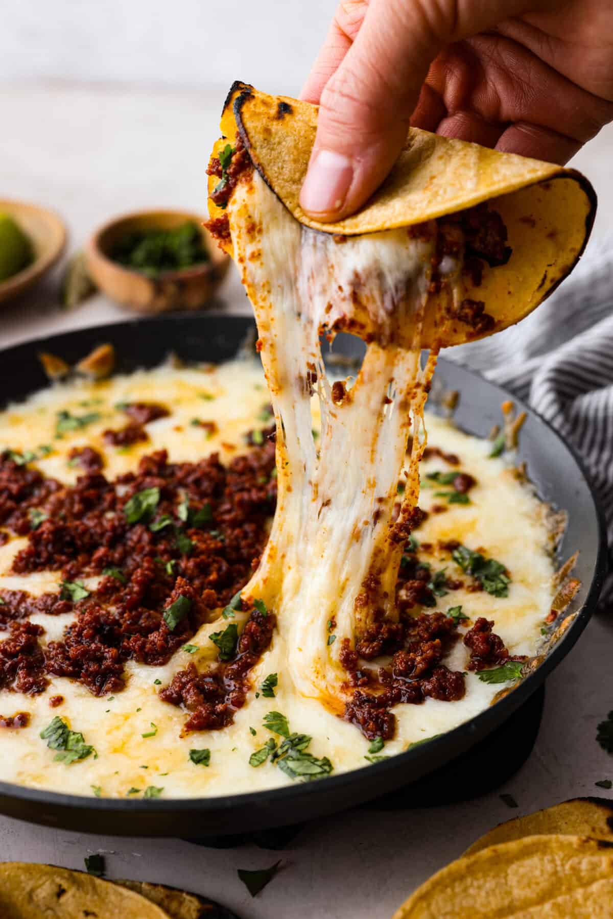 Angle shot of stretchy queso fundido. 