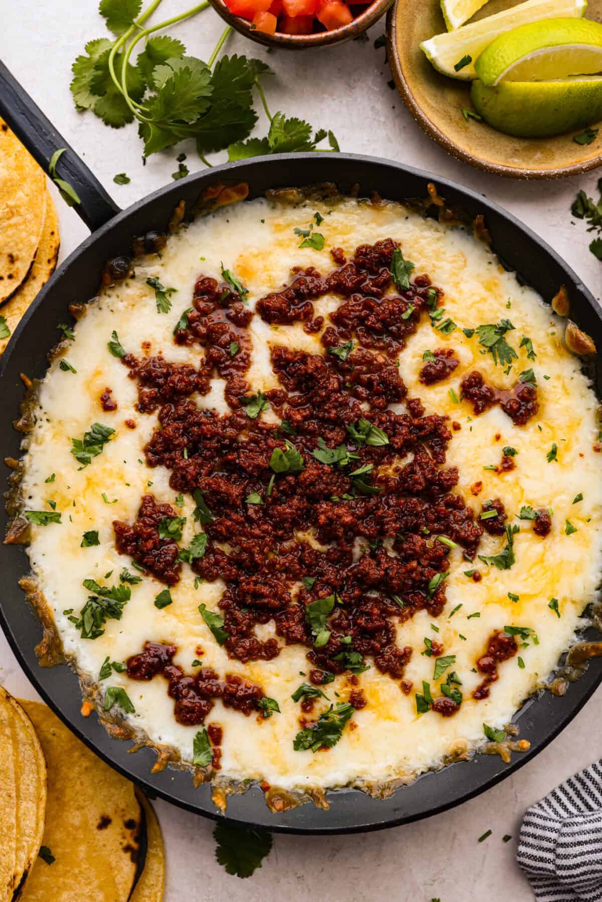 Overhead shot of queso fundido in a skillet. 