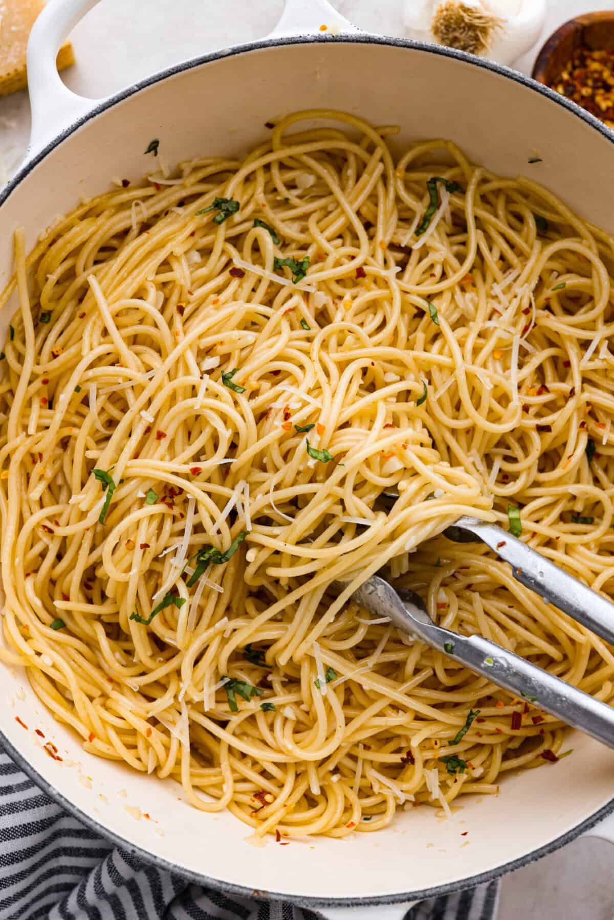 Overhead shot of spaghetti aglio e olio in a pot. 