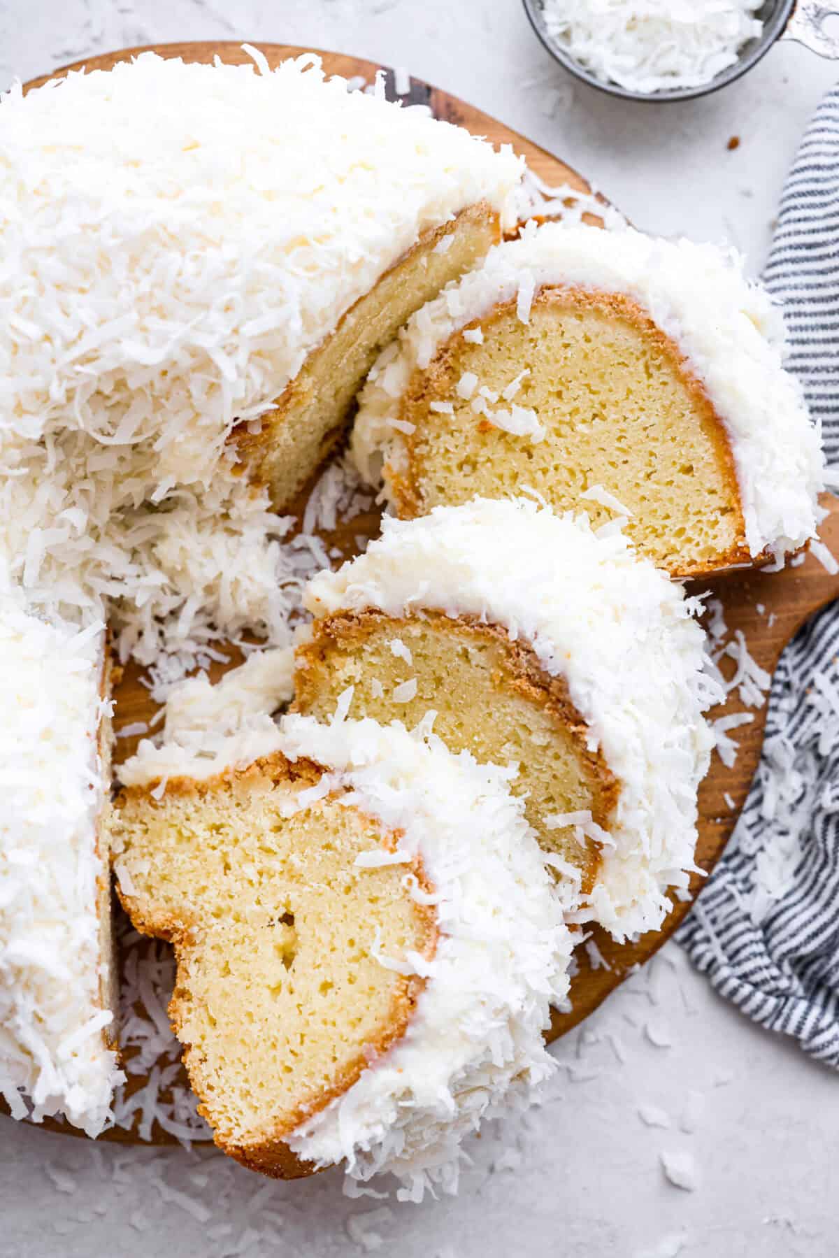 Overhead shot of the Tom Cruise coconut cake with a few pieces cut and turned on their side. 