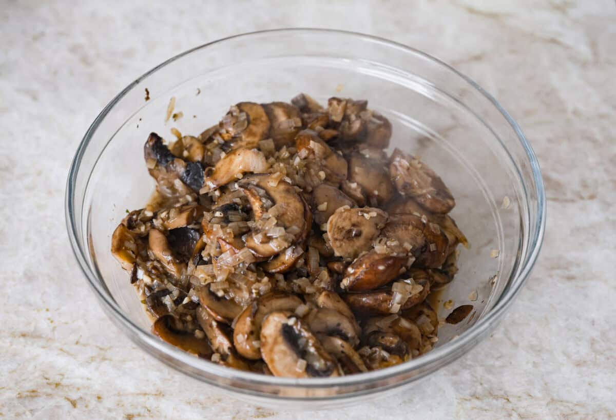 Overhead shot of the cooked mushrooms, garlic and shallots in a bowl. 