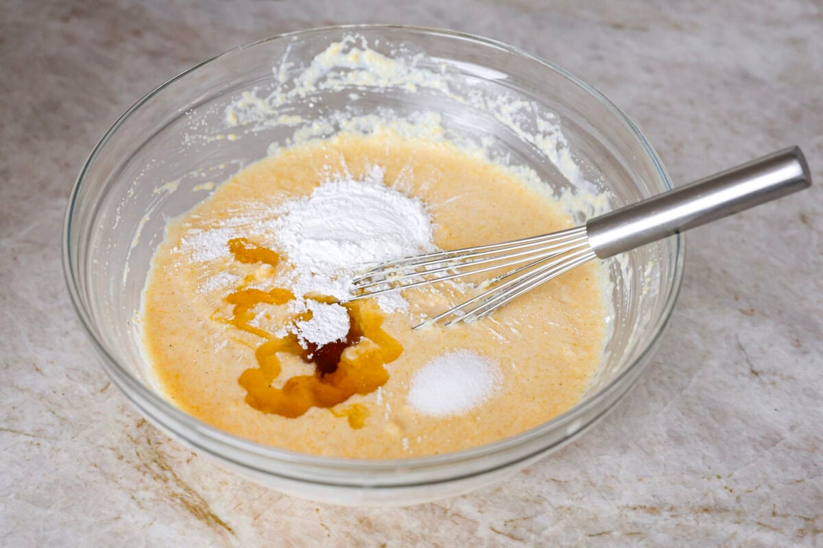 Angle shot of the cornmeal and milk mixture with honey, egg yolks, baking powder and salt. 