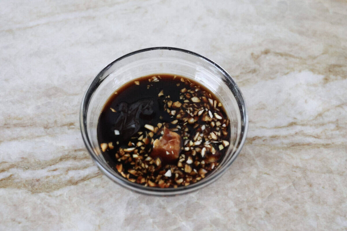 Overhead shot of sauce ingredients in a mixing bowl. 