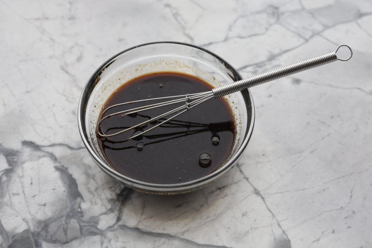 Angle shot of ingredients whisked together in a bowl. 