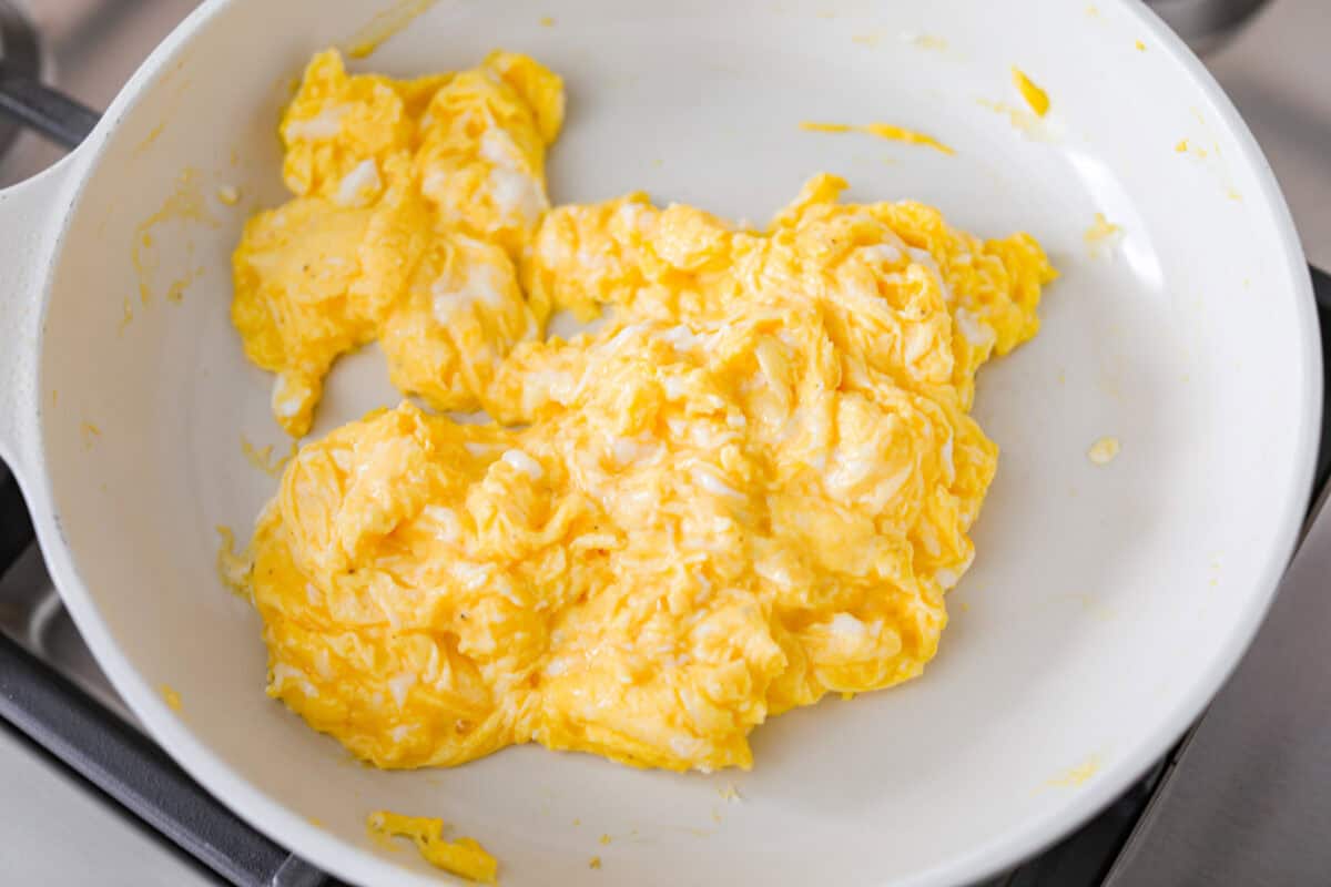 Overhead shot of scrambled eggs in a skillet. 