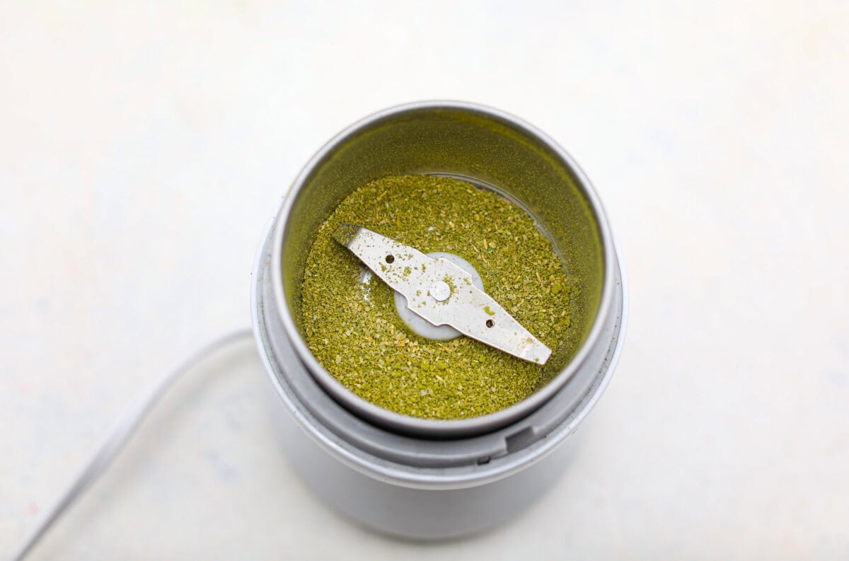 Overhead shot of the ground up bay leaves in the grinder. 