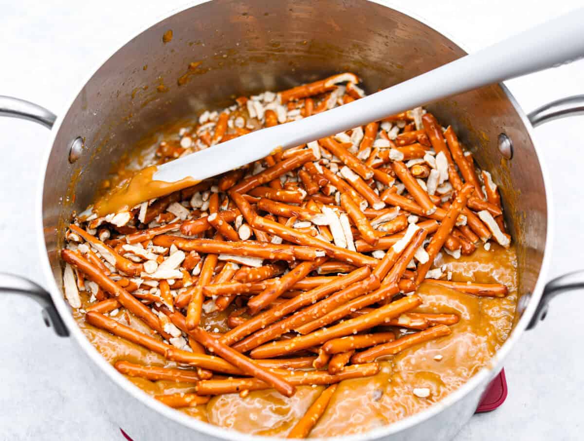 Overhead shot of pretzels in caramel mixture. 