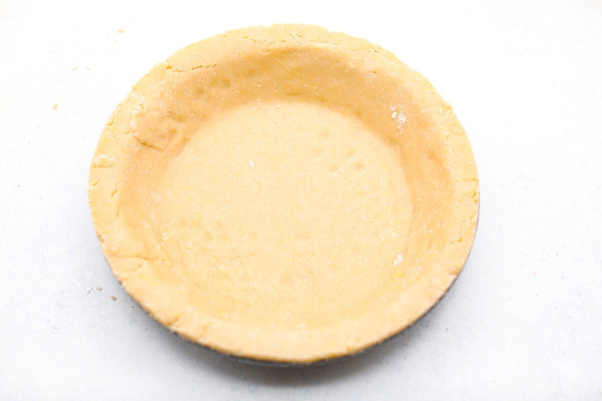 Overhead shot of the pie crust pressed into a pie plate. 