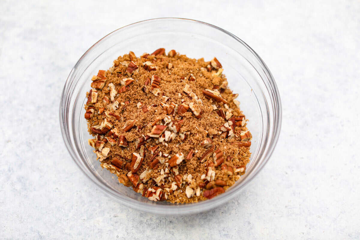 This Sock It to Me Cake is a moist, buttery Southern bundt cake with a delicious cinnamon-sugar pecan layer swirled through the middle. It became popular because of Duncan Hines in the 1960s and 1970s, and you'll understand why once you try it! Overhead shot of cinnamon, brown sugar and pecans mixed in a bowl.
