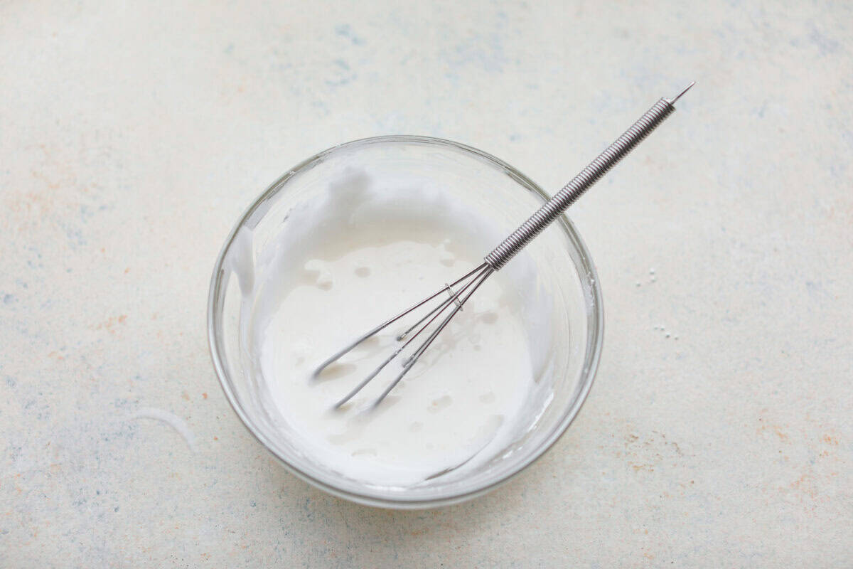 Overhead shot of the glaze ingredients whisked together in a small bowl. 