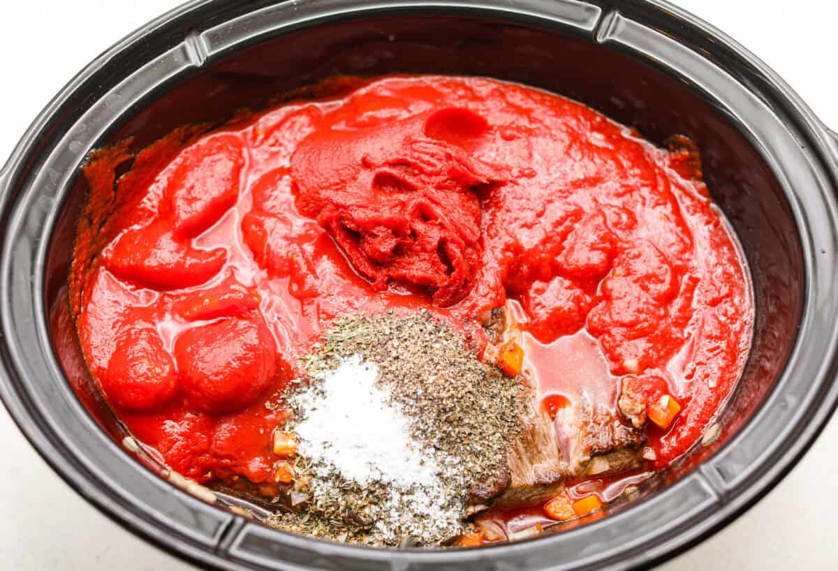 Overhead shot of all of the ingredients added to the slow cooker. 