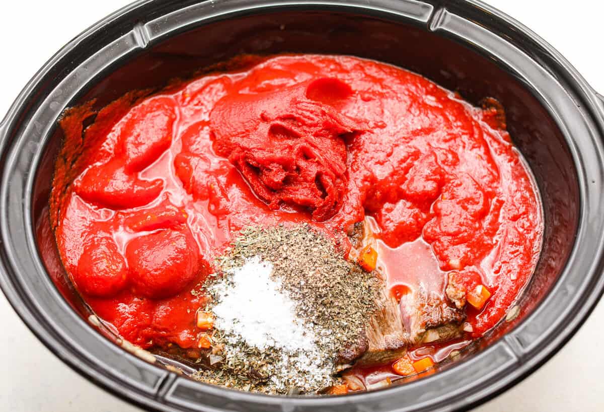 Slow cooker Sunday sauce, also known as Overhead shot of all of the ingredients added to the slow cooker.