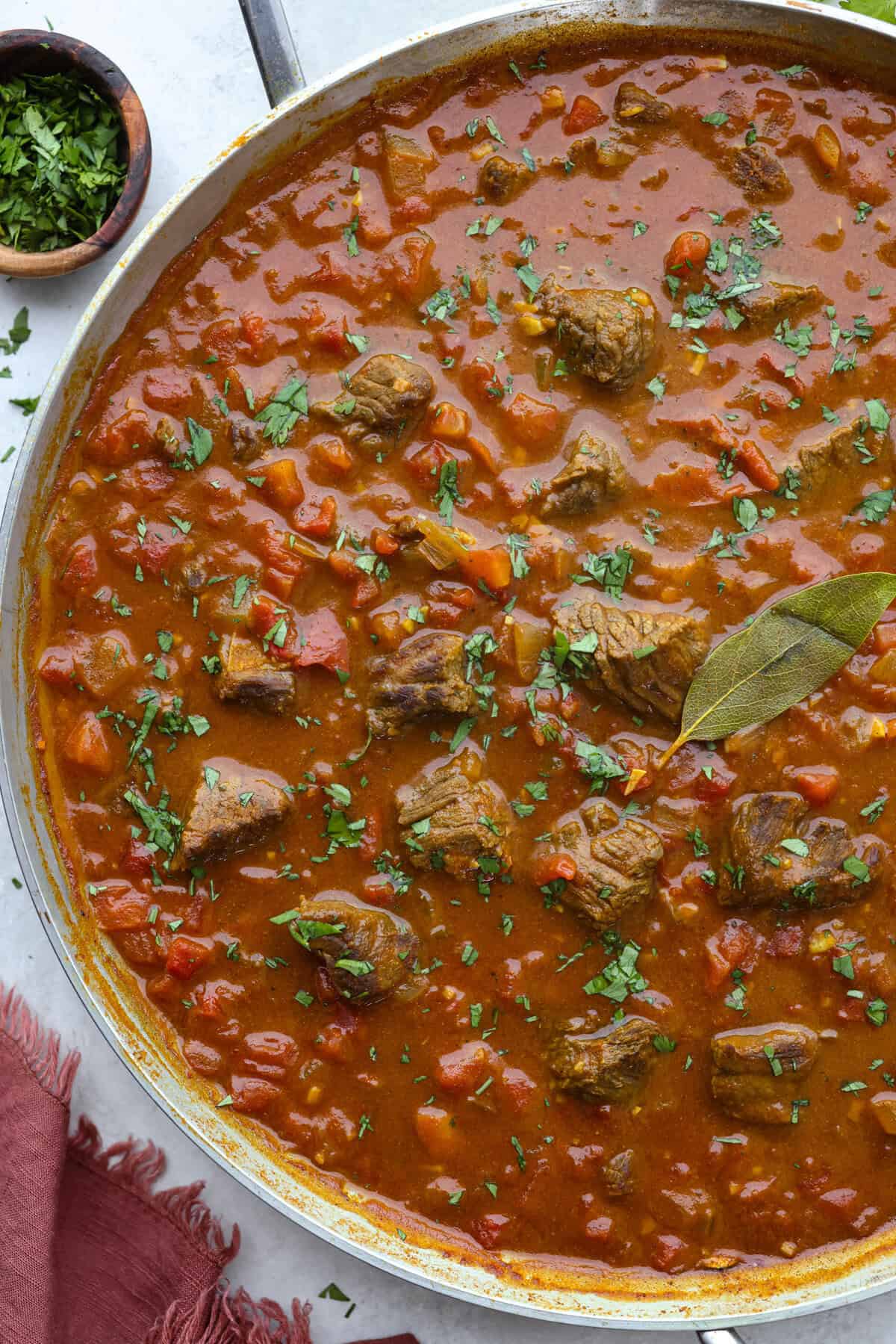 Comforting beef curry is a perfect blend of hearty and flavorful! With its mild spice level, it’s a dish that everyone can enjoy, but you can easily turn up the heat with a pinch of red pepper. Pair it with rice or naan for the ultimate cozy dinner! Overhead shot of beef curry in a skillet.