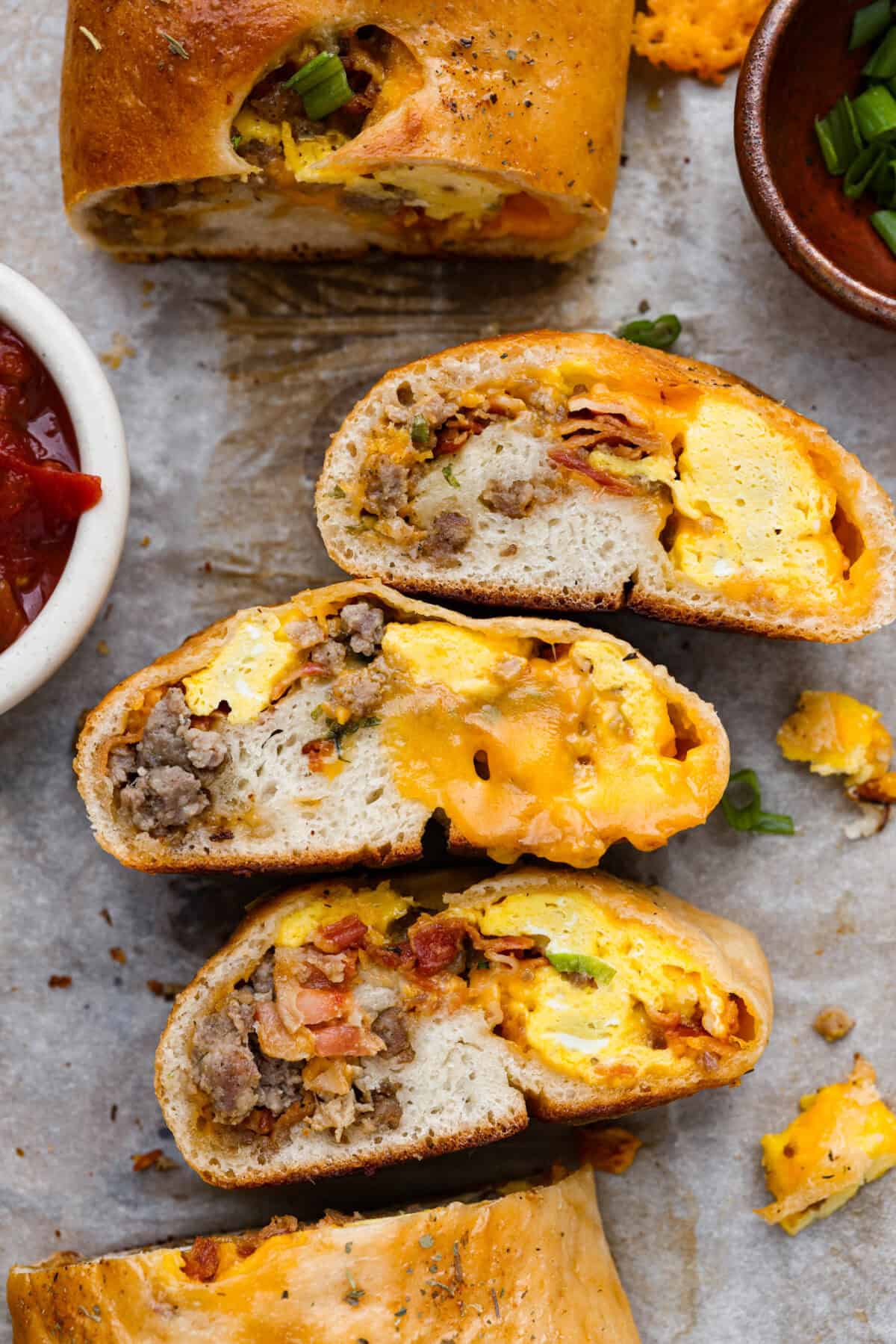 Overhead shot of sliced breakfast Stromboli on their sides. 