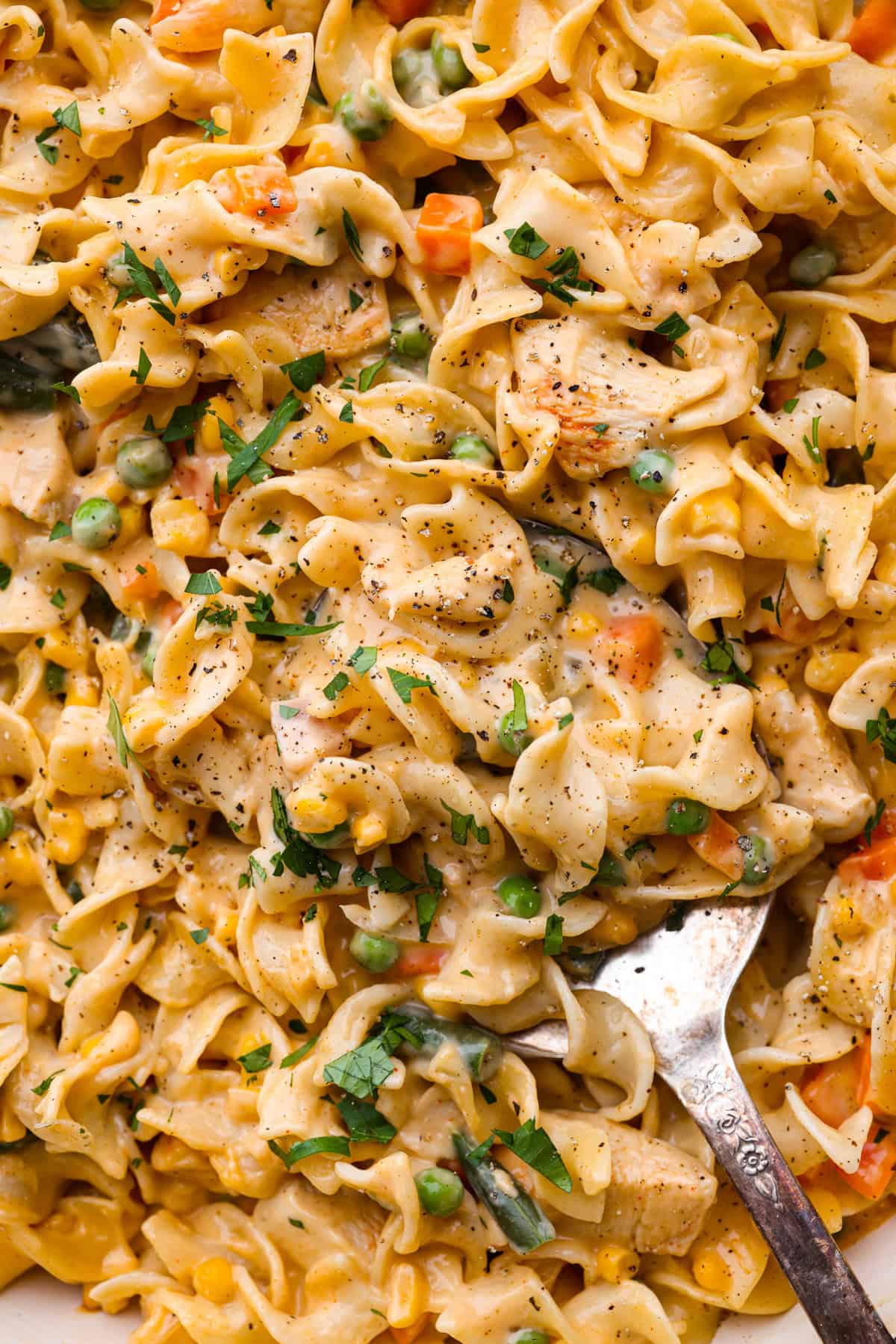 Chicken Pot Pie Pasta is a quick and easy twist on the classic comfort food. This one-pan recipe includes all the creamy, hearty flavors of a traditional chicken pot pie but swaps the pie crust for tender noodles. It’s a simple, fuss-free meal ready in just 30 minutes! Close up shot of chicken pot pie pasta.