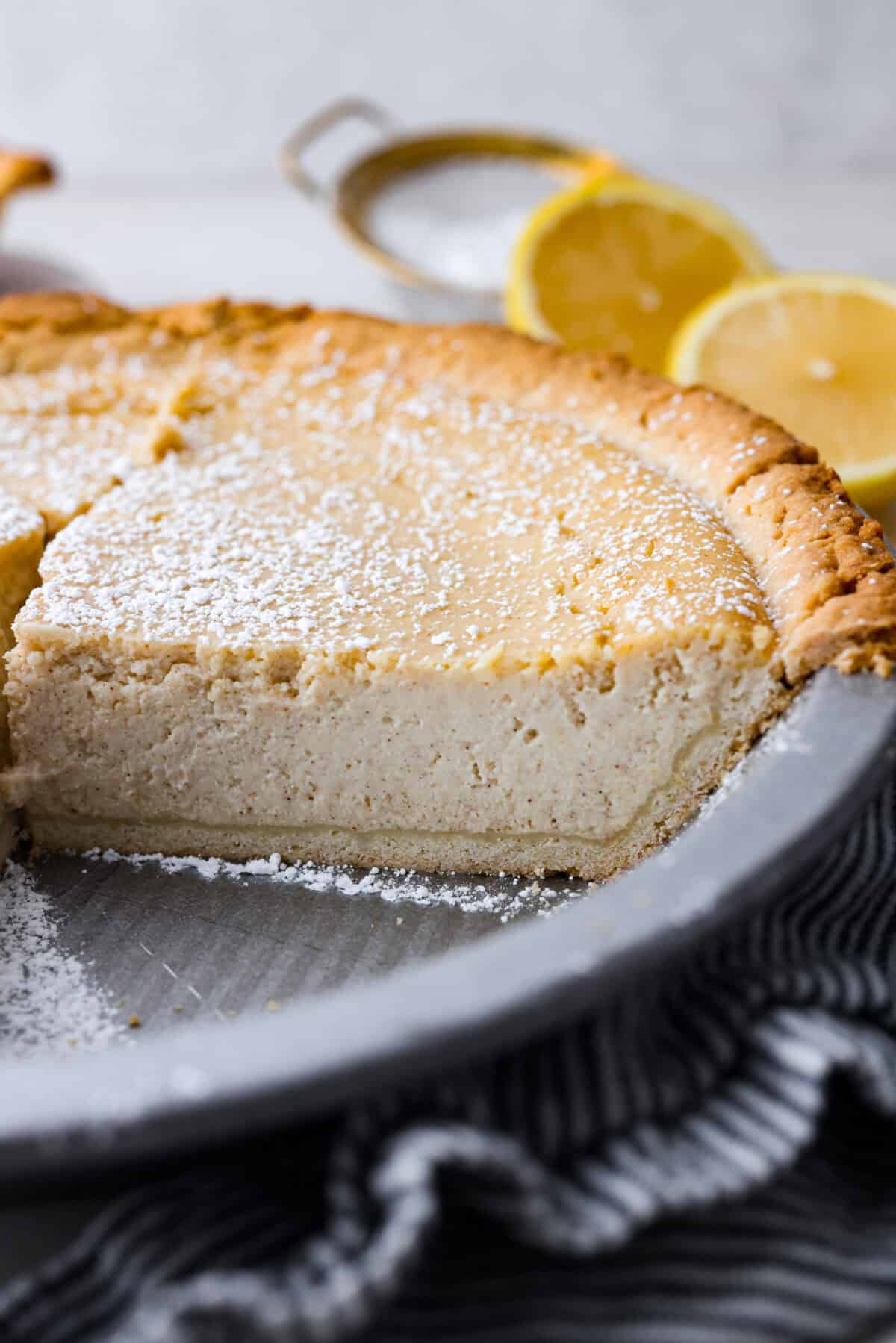 Close up shot of the ricotta pie with a piece taken out.