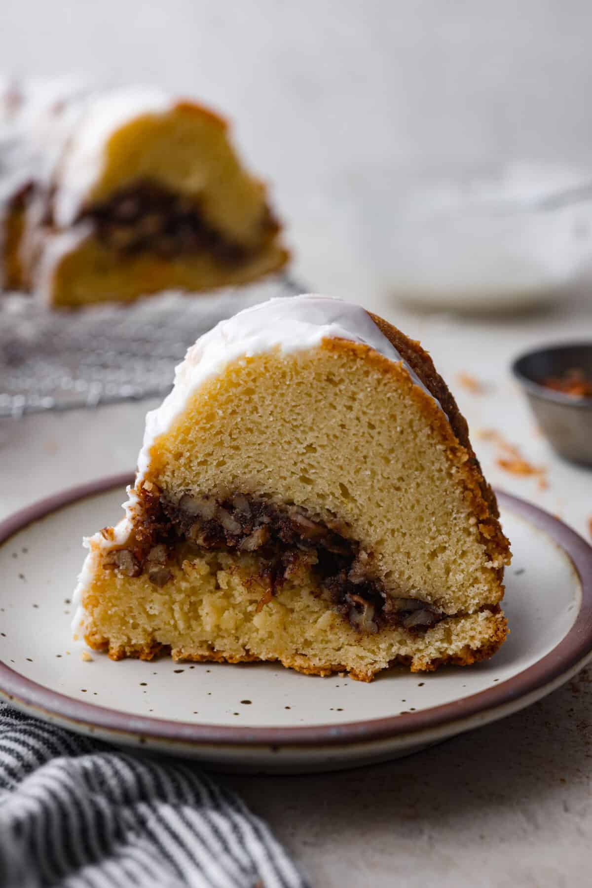 Side shot of a slice of sock it to me cake on a plate. 