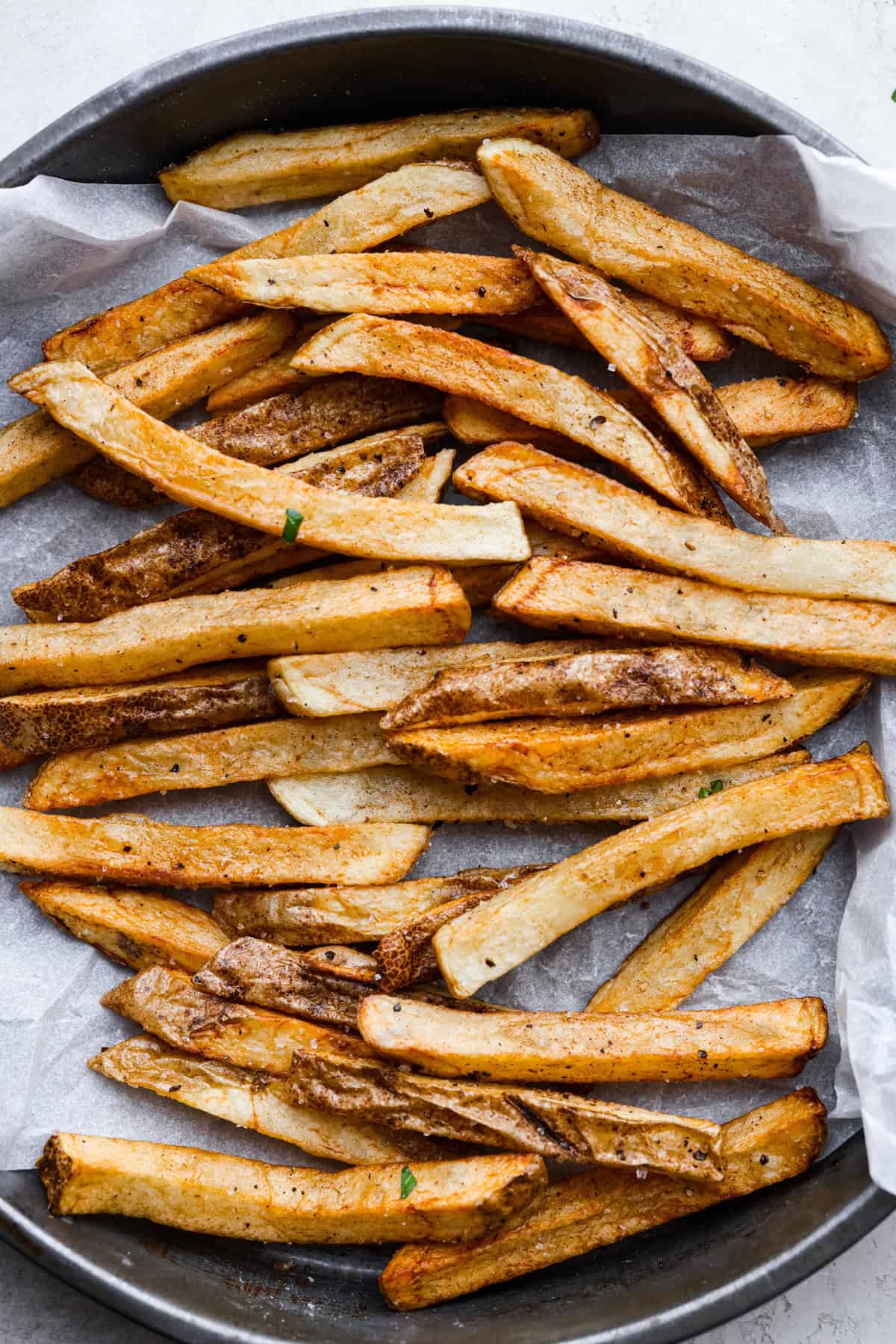 Steak Frites is a classic French bistro dish that combines perfectly seared, juicy steak with crispy, golden fries. It's a simple yet delicious meal that is filled with rich flavors and satisfying crunch. You will love this restaurant-quality dinner made right in your own kitchen! Overhead shot of the fries for steak frites.
