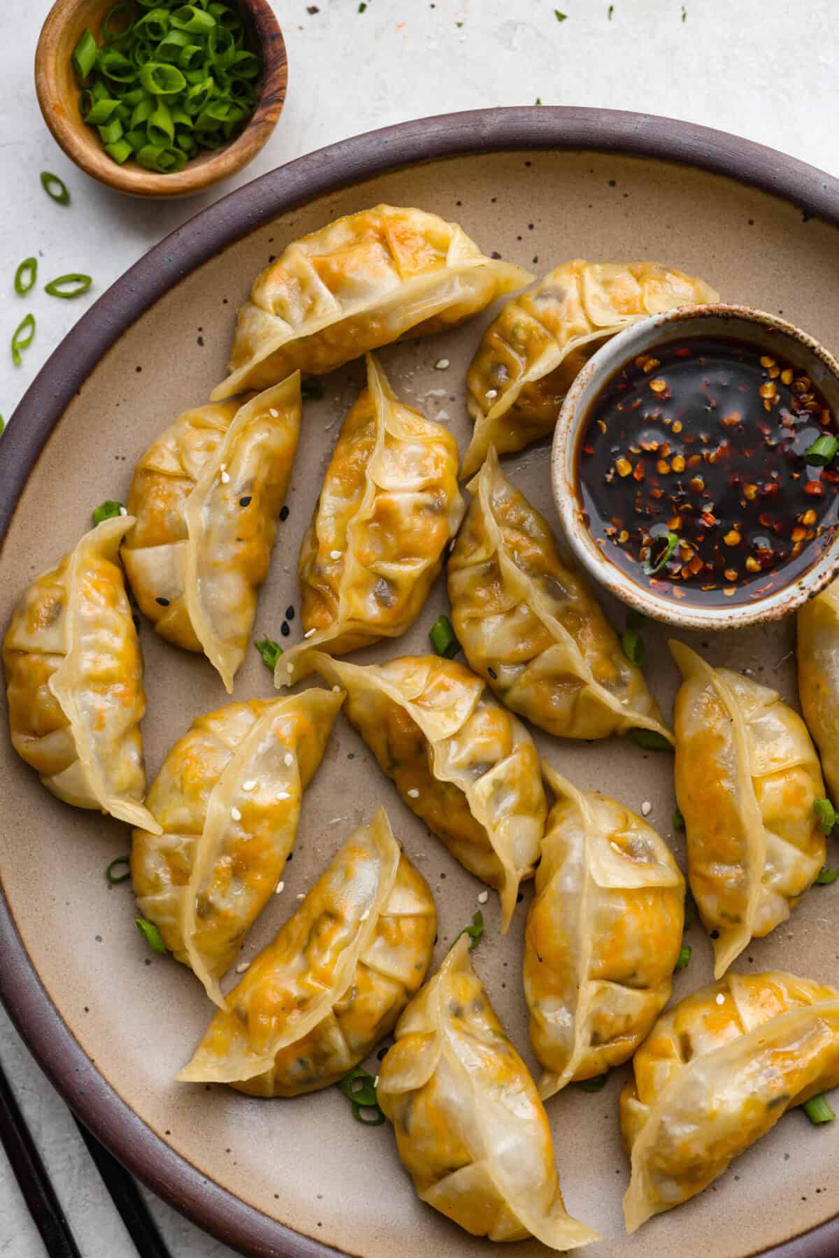 Overhead shot of vegetbale dumplings on a serving plate. 