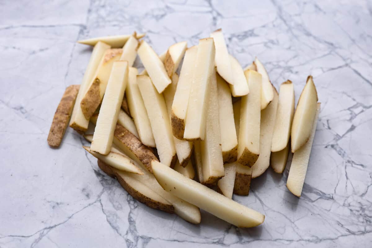 Overhead shot of sliced up potatoes with the skin on. 