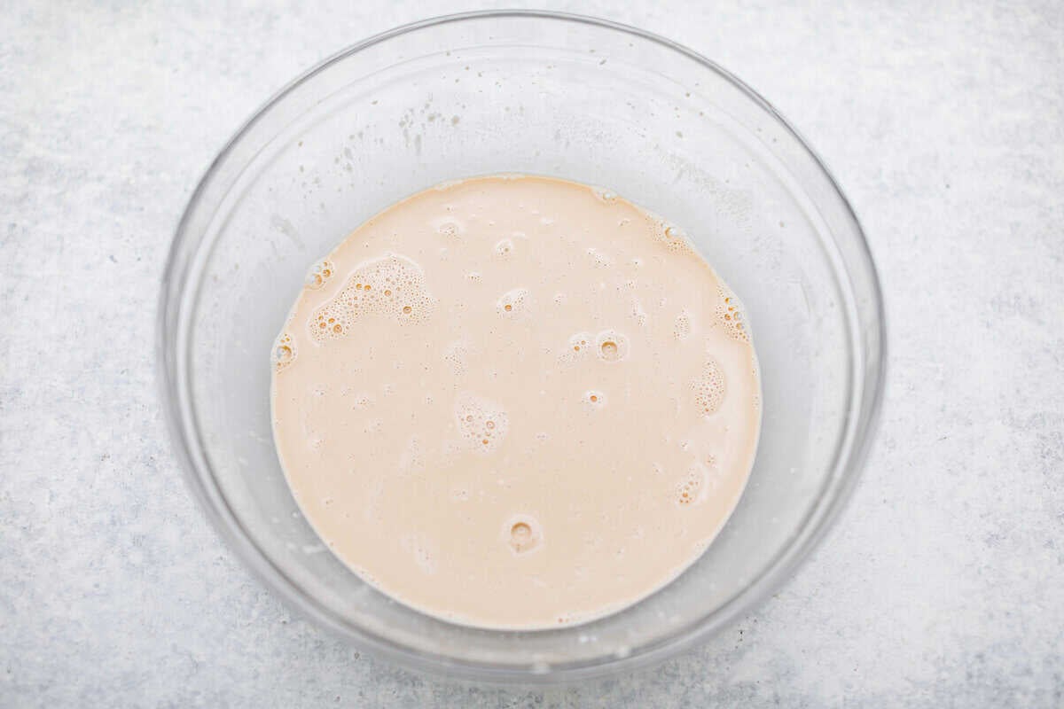 Chocolate Mayonnaise Cake is a rich, moist, and decadent dessert that’s super easy to make! The mayonnaise adds extra moisture and creates a soft, tender crumb. Whether for a special occasion or just because it's sure to impress! Overhead shot of mayonnaise, coffee, eggs and vanilla whisked together in a bowl.