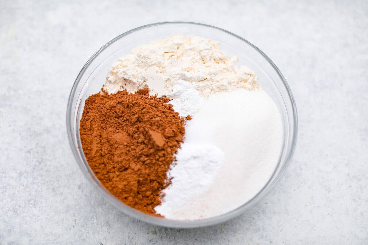 Overhead shot of flour, cocoa powder, and sugar in a bowl. 